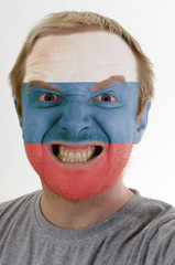 Face of crazy angry man painted in colors of russia flag