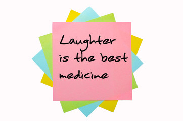 Proverb "Laughter is the best medicine" written on bunch of stic