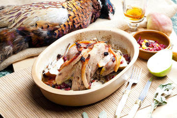 baked pheasant with bacon, pear, raisins on brandy
