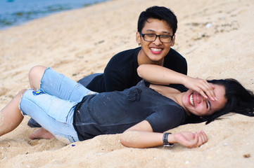 Fototapeta na wymiar happy asian couple lying down at beach