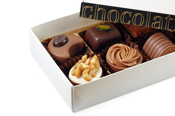 Box of assorted chocolates on white background