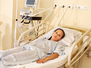 Woman on gurney in operating room.