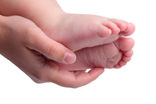 Childs feets in mother hand