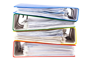 Stacked red, green, blue and yellow office folders  isolated on
