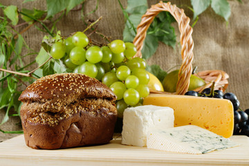 Bread, cheese and grapes still life