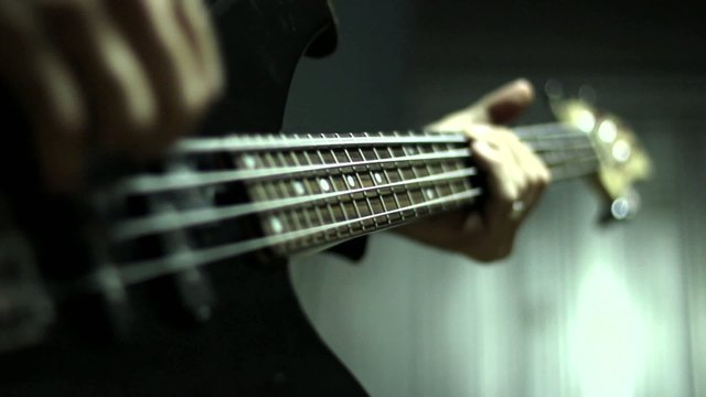 Man playing electrical bass guitar