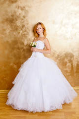 Beautiful red haired woman in white bridal dress