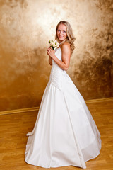 Fototapeta na wymiar Beautiful blonde haired woman in white bridal dress