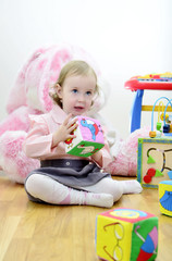 little girl in a room with toys