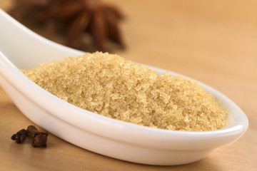 Brown granulated cane sugar with cloves and star anise