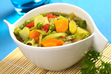 Vegetable soup made of carrot, leek, pea, potato, onion, tomato
