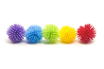 Five Colorful Stess Koosh Balls in a line
