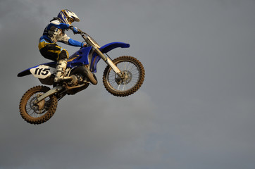 The spectacular jump motocross racer on a motorcycle