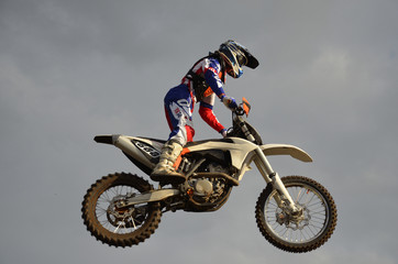 The spectacular jump motocross racer on a motorcycle