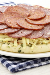 raw salami and pepperoni pizza