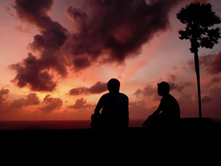 silhouetted two man at sunset