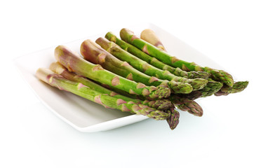 delicious fresh asparagus on a plate isolated on white