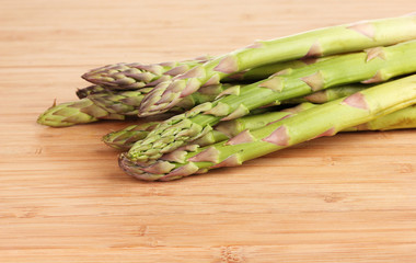 delicious asparagus on wooden background