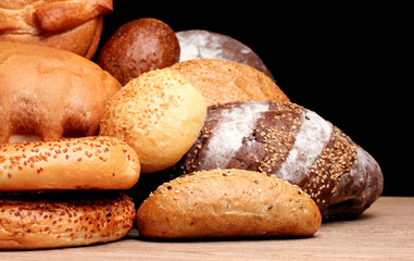 delicious bread on wooden table on brown background