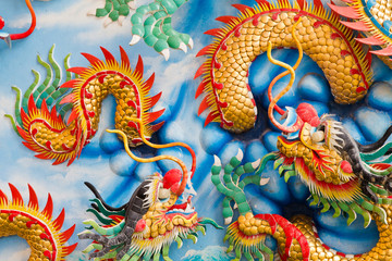 Fototapeta premium Statue of a dragon on the wall.