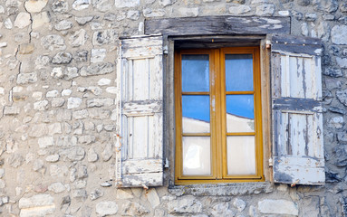 Fototapeta na wymiar Window on old stone house in Sault, Provence in France