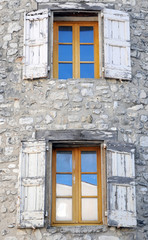 Fototapeta na wymiar Windows on old stone house in Sault, Provence in France