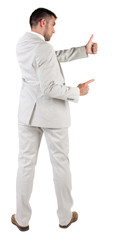 Back view of young business man in white suit going thumb up