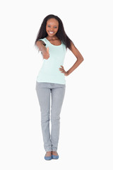 Woman giving thumb up on white background