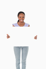 Happy woman presenting placeholder on white background