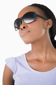 Close up of woman wearing her sunglasses against a white backgro