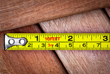 Measuring tape over wooden boards