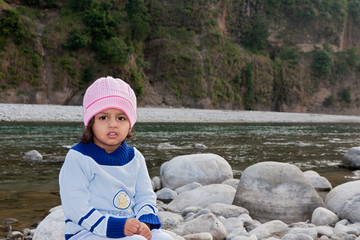 Little Girl sitting on the Kosi River Side - obrazy, fototapety, plakaty