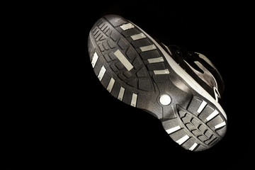 Sole of the boot on the black background