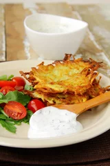 Foto op Canvas potato pancakes with dill and sour cream © Olga Kriger