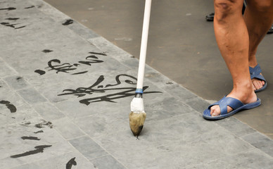 man doing chinese calligraphy