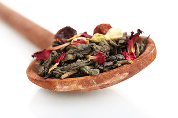 Green dry jasmin tea in woooden spoon isolated on white