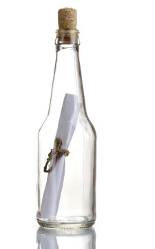 Glass bottle with note inside isolated on white