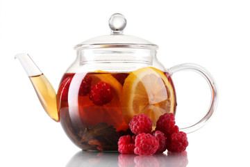 Glass black fruit tea in glass teapot isolated on white