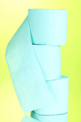 blue rolls of toilet paper on green background