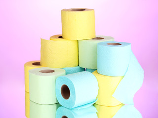 bright rolls of toilet paper on pink background