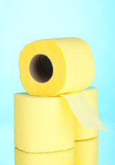 yellow rolls of toilet paper on blue background