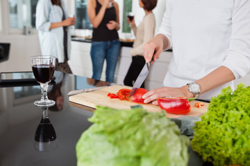 Cropped image of female cutting vegetables