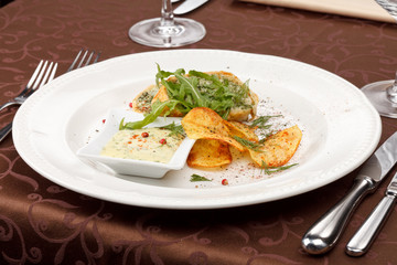 fish pie with sauce and potato chips