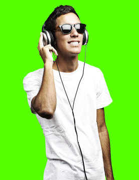 man listening music against a removable chroma key background