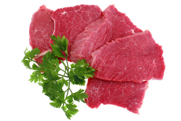 Cut of  beef steak with green leaf. Isolated.