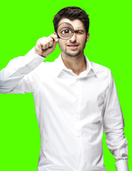 man with magnifying glass over removable chroma key background