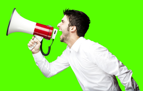 man shouting with megaphone over removable chroma key background