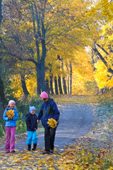 Family in autumn maple park