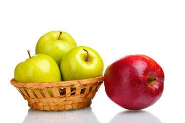 juicy green apples in basket and red apple isolated on white