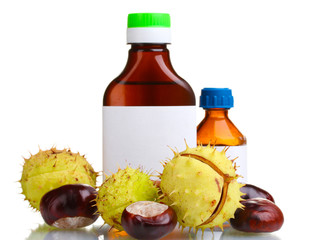 green and brown chestnuts and medical bottles isolated on white